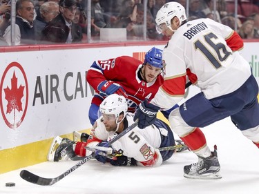 Canadiens' Andrew Shaw checks Florida Panthers' Aaron Ekblad as Panthers Aleksander Barkov grabs loose puck in Montreal on Friday, Sept. 29, 2017.