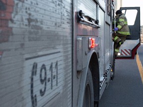 A Montreal fireman from Station 5 climbs into his truck after responding to a person in distress call in Montreal, December 30, 2014.