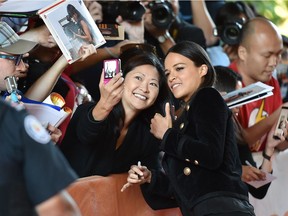 Actress Michelle Rodriguez poses for a photo with a fan at the "Assignment" première on day 7 of the Toronto International Film Festival at the Ryerson Theatre on Sept. 14, 2016, in Toronto.