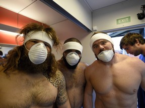 Italy's prop Martin Castrogiovanni (L) and flanker Samuela Vunisa (C) pose before entering a cryotherapy chamber at the University of Surrey in Guildford, south England on Sept. 16, 2015 ahead of the Rugby Union World Cup.