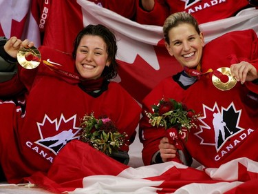 Goalkeepers Charline Labonté #32 and Kim St-Pierre #33 of Canada pose with their gold medals after the final of the women's ice hockey between Sweden and Canada during Day 10 of the Turin 2006 Winter Olympic Games on February 20, 2006 at the Palasport Olimpico in Turin, Italy. Canada won 4-1.