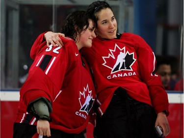 Charline Labonté #32 and Caroline Ouellette #13 of Canada celebrate together after defeating Sweden 4-1 during the final of the women's ice hockey on Day 10 of the Turin 2006 Winter Olympic Games on February 20, 2006 at the Palasport Olimpico in Turin, Italy.