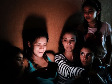 A family sits in a hallway as they ride out Hurricane Irma in a hotel Sept. 10, 2017, in Fort Myers, Florida. (Spencer Platt, Getty Images)