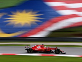 Sebastian Vettel steers his Ferrari during practice for the Malaysian Grand Prix. He posted the fastest lap time of the day.