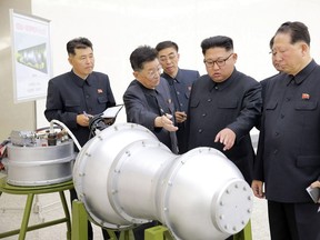 This undated picture released by North Korea's official Korean Central News Agency (KCNA) on September 3, 2017 shows North Korean leader Kim Jong-Un (C) looking at a metal casing with two bulges at an undisclosed location. North Korea has developed a hydrogen bomb which can be loaded into the country's new intercontinental ballistic missile, the official Korean Central News Agency claimed on September 3.