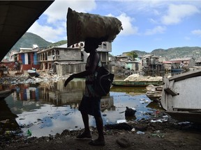 A woman walks next to the Mapou River, in Shadaa neighborhood, in Cap-Haitien, in the north of Haiti, ahead of Hurricane Irma Sept. 5, 2017.