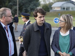 French journalist Loup Bureau (C) stands with French Culture Minister Françoise Nyssen (R) as he addresses media representatives after his arrival at Roissy-Charles de Gaulle Airport on the outskirts of Paris on September 17, 2017.