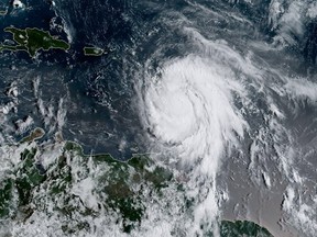 This satellite image obtained from the National Oceanic and Atmospheric Administration (NOAA) shows Hurricane Maria at 1215 UTC on September 18, 2017.