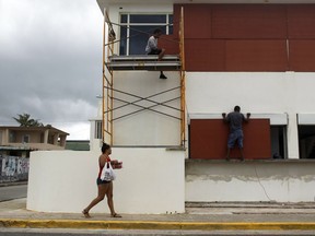People board up windows of a business in preparation for Hurricane Maria in Luquillo, Puerto Rico, Sept. 19, 2017. Maria headed towards the Virgin Islands and Puerto Rico on Tuesday after battering the eastern Caribbean island of Dominica.