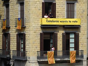SPAIN-CATALONIA-POLITICS-REFERENDUM

Catalan flags and a pro-referendum banner hang on a building facade in Sant Jaume square on September 23, 2017 in Barcelona. Spain's Prime Minister Mariano Rajoy asked Catalan separatist leaders today to own up they can't hold an outlawed independence referendum after a crackdown dealt them a serious blow this week. / AFP PHOTO / LLUIS GENELLUIS GENE/AFP/Getty Images
LLUIS GENE, AFP/Getty Images