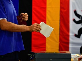 A man casts his ballot at a polling station in Berlin during general elections on September 24, 2017. Polls opened in Germany in a general election expected to hand Chancellor Angela Merkel a fourth term, while the hard-right Alternative for Germany (AfD) party is predicted to win its first seats in the national parliament.