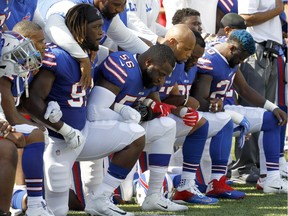 Buffalo Bills players kneel during the national anthem prior to an NFL football game against the Denver Broncos on  Sunday, Sept. 24, 2017, in Orchard Park, N.Y.