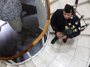 Wearing a Black Watch tie and Ogilvy tartan, piper Jeffrey McCarthy plays his Great Highland Bagpipe at Ogilvy department store in Montreal in this December 2013 file photo.