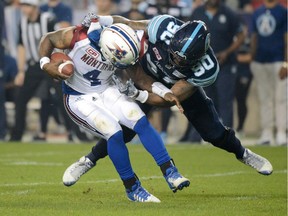 Montreal Alouettes quarterback Darian Durant (4) is hit by Toronto Argonauts defensive lineman Cleyon Laing (90) during first half CFL football action in Toronto on Saturday, Sept. 23, 2017.