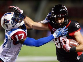 Ottawa Redblacks wide-receiver Brad Sinopoli (88) fends off a tackle from Montreal Alouettes defensive-back Brandon Stewart during second half CFL football action in Ottawa on Wednesday, July 19, 2017.