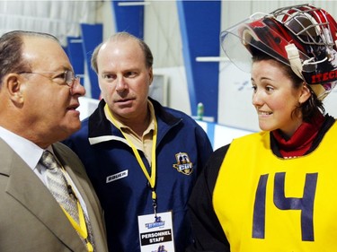 Goalie Charline Labonté hoping to make the cut on the CBC reality series Making the Cut, gets encouragement from Scotty Bowman and Mike Keenan at 4 Glaces Arena in Brossard on June 18, 2004.