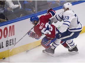 Canadiens defenceman Victor Mete is tripped by Maple Leafs' Eric Fehr during second period pre-season action in Quebec City.