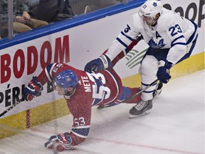 Montreal Canadiens' Victor Mete is tripped by Toronto Maple Leafs' Eric Fehr during second period NHL pre-season action Wednesday, September 27, 2017 in Quebec City.