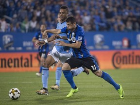 Impact midfielder Blerim Dzemaili, right, tries to get ahead of New York City FC forward Khiry Shelton during first half MLS action at Saputo Stadium Wednesday night.