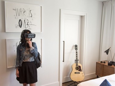 A woman dons a virtual-reality headset in the Queen E's revamped Suite 1742, made famous by John Lennon and Yoko Ono during their 1969 bed-in for peace, Thursday, September 21, 2017 in Montreal. THE CANADIAN PRESS/Paul Chiasson