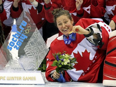 Team Canada goalie Charline Labonté of Boisbriand poses with other players for a team picture after beating Team USA 3-2 in overtime to win the women's ice hockey gold medal at the Bolshoy Ice Dome at the Sochi 2014 Winter Olympics in Sochi, Russia, on Thursday Feb. 20, 2014.