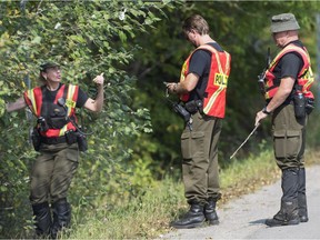 Quebec provincial police officers search the side of a road for evidence into the disappearance of a man and a young boy in Lachute, Que., Friday, September 15 , 2017. He was found safe and a 41-year-old man was arrested. THE CANADIAN PRESS/Graham Hughes