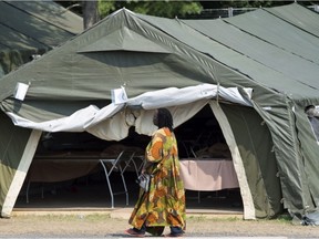 An asylum seeker walks through a temporary camp Monday, August 21, 2017 near St-Bernard-de-Lacolle.cope with the crush of asylum seekers crossing into Canada from the United States. THE CANADIAN PRESS/Paul Chiasson ORG XMIT: pch108
Paul Chiasson,