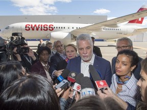 Quebec Premier Philippe Couillard speaks to the media after addressing Bombardier employees at the company's CSeries plant on Thursday.