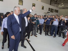 Quebec Premier Philippe Couillard greets Bombardier employees as he arrives at the company's CSeries plant, Thursday, September 28, 2017 in Mirabel, Que.