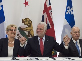 Philippe Couillard, Kathleen Wynne, Edmund G.  Brown

Quebec Premier Philippe Couillard, flanked by Ontario Premier Kathleen Wynne, left, and California Governor Edmund G. Brown, raise their hands after signing an agreement on climate change in Quebec City on Friday, Sept. 22, 2017. THE CANADIAN PRESS/Jacques Boissinot ORG XMIT: JQB101
Jacques Boissinot,