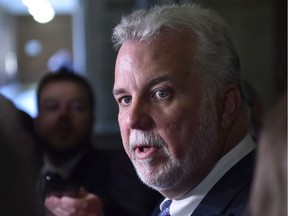 Quebec Premier Philippe Couillard responds to reporters' questions on House leader Jean-Marc Fournier, Tuesday, Sept. 19, 2017 at the legislature in Quebec City.