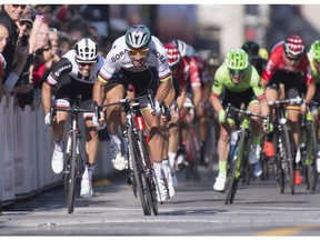 Peter Sagan, centre left, of Slovakia sprints to the finish to win his 100th professional race, at the UCI Grand-Prix cycliste Friday, September 8, 2017 in Quebec City. Michael Matthews of Australia, left, sprints to a third place finish.