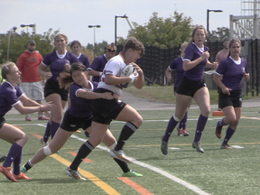 Gabriella Dobias breaks a tackle during a rugby match on Sept. 1, 2017