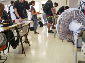 Fans are used to cool an overheated classroom:  Most Montreal schools aren't equipped with air conditioning.