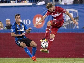 Chicago Fire midfielder Djordje Mihailovic gets the ball ahead of Montreal Impact defender Daniel Lovitz during second half MLS action Aug. 16, 2017 in Montreal.