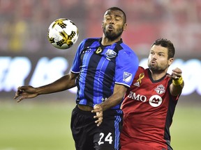 Montreal Impact forward Anthony Jackson-Hamel (24) battles for the ball with Toronto FC defender Drew Moor (3) during first half MLS soccer action in Toronto on Wednesday, September 20, 2017.