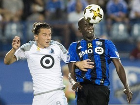 Impact's Hassoun Camara, right, challenges Minnesota United FC's Marc Burch during second half MLS soccer action in Montreal on Saturday, Sept. 16, 2017.