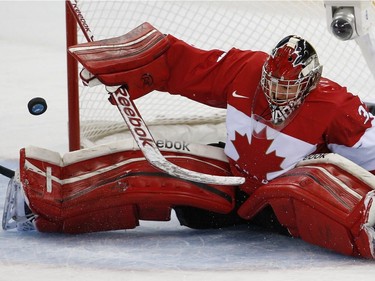 Goalkeeper Charline Labonté of Canada bats the the puck away during the 2014 Winter Olympics women's ice hockey game against the United States at Shayba Arena, Wednesday, Feb. 12, 2014, in Sochi, Russia.