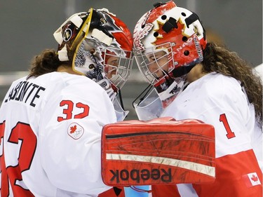 Goalkeeper Charline Labonté of Canada celebrates Canada's 3-1 victory over Switzerland with Goalkeeper Shannon Szabados, right, after the 2014 Winter Olympics women's semifinal ice hockey game at Shayba Arena, Monday, Feb. 17, 2014, in Sochi, Russia.