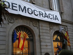 Pro-Spanish unity demonstrators attempt to climb the facade of Barcelona City Hall to reach a banner reading in Catalan "More Democracy" Saturday, Sept. 30 2017. Catalonia's planned referendum on secession is due to be held Sunday by the pro-independence Catalan government but Spain's government calls the vote illegal, since it violates the constitution, and the country's Constitutional Court has ordered it suspended. (AP Photo/Bob Edme) ORG XMIT: XAF137
Bob Edme, AP