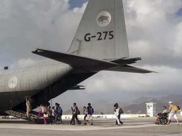 People board a military plane on St. Maarten, after the passage of Hurricane Irma.