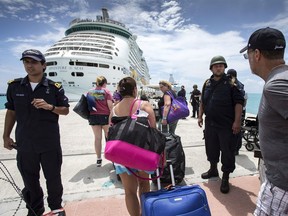 People walking toward a cruise ship anchored on St. Maarten, after the passage of Hurricane Irma. Irma cut a path of devastation across the northern Caribbean, including this island that is split between French and Dutch control.