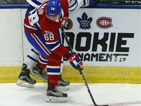 Cole Coskey of the Toronto Maple Leafs rookies dodges a hit from Canadiens' Alexandre Alain during rookie camp at the Ricoh Coliseum in Toronto on Friday September 8, 2017.