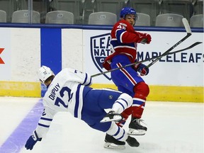 Jean Dupuy of the Toronto Maple Leafs gets knocked down by Canadiens' Josh Brook during rookie camp at the Ricoh Coliseum in Toronto on Friday, Sept. 8, 2017.