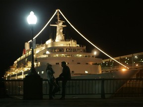 A couple hangs out near a cruise ship in the Old Port of Montreal in 2007.