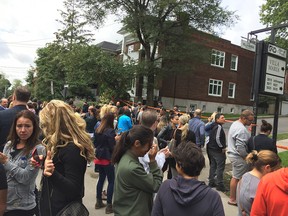 Parents gather outside Villa Maria College after the Montreal high school was evacuated because of an emergency alarm. Police said the alarm was unfounded.
