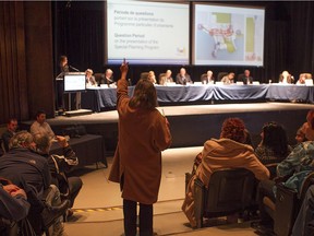 A resident asks a question during a public consultation meeting to discuss development plans for the Pointe-Claire Village sector in February 2016.