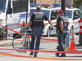 Montreal police officers are shown at the scene of an accident involving a cyclist and a truck driver on Berri St. on Aug. 26, 2016.