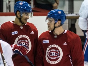 Canadiens captain Max Pacioretty and Jonathan Drouin, right, chat during practice at the Bell Sports Complex in Brossard last month.