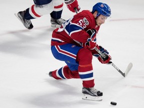 Canadiens defenceman Victor Mete struggles to control the puck during preseason NHL play against the Washington Capitals at the Bell Centre in Montreal on Wednesday September 20, 2017.